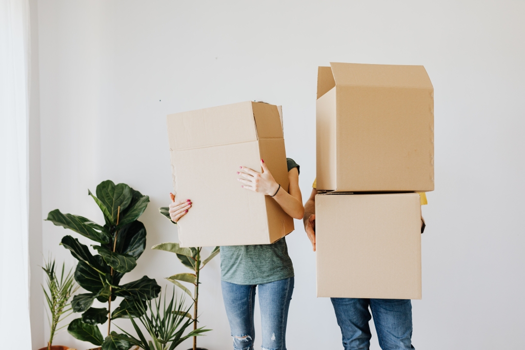 Image of Couple Holding Moving Boxes